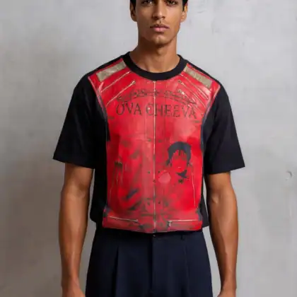 A man with short dark hair stands against a light gray wall, wearing the OVA CHEEVA Men’s Heavy Cotton Michael Jackson Beat It Graphic T-Shirt, which features text and an illustrated portrait on the front.