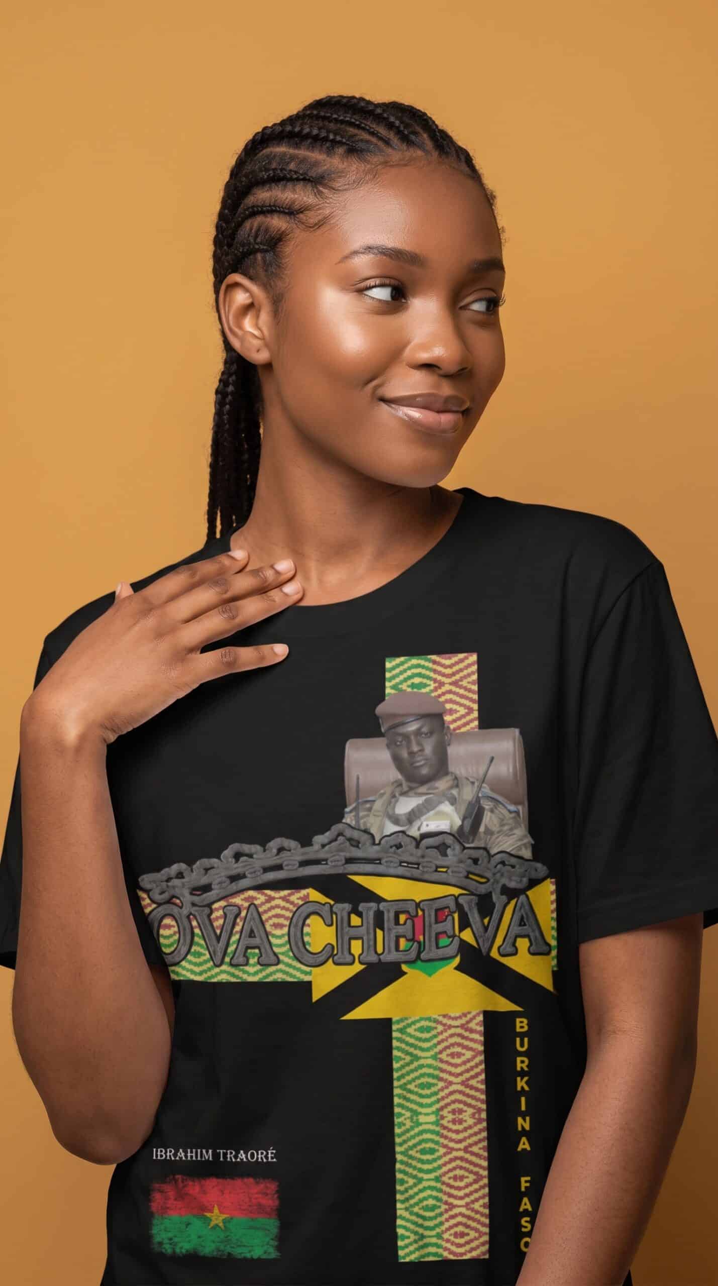 A woman with braided hair wearing a black T-shirt featuring a graphic design and the text "Viva Chev.