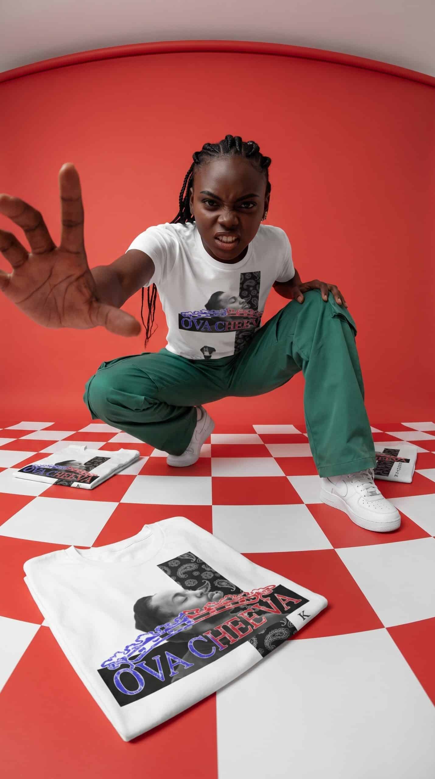 A woman crouching on a red and white checkered floor, reaching towards the camera with a fierce expr.