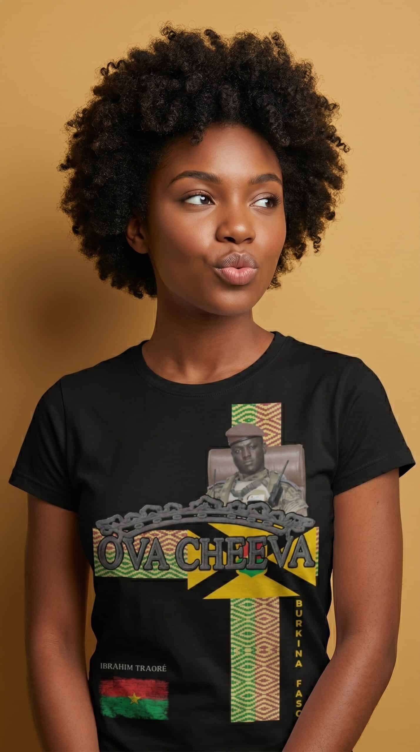 A woman with natural curly hair wearing a black T-shirt featuring a graphic design of Ova Cheva and.