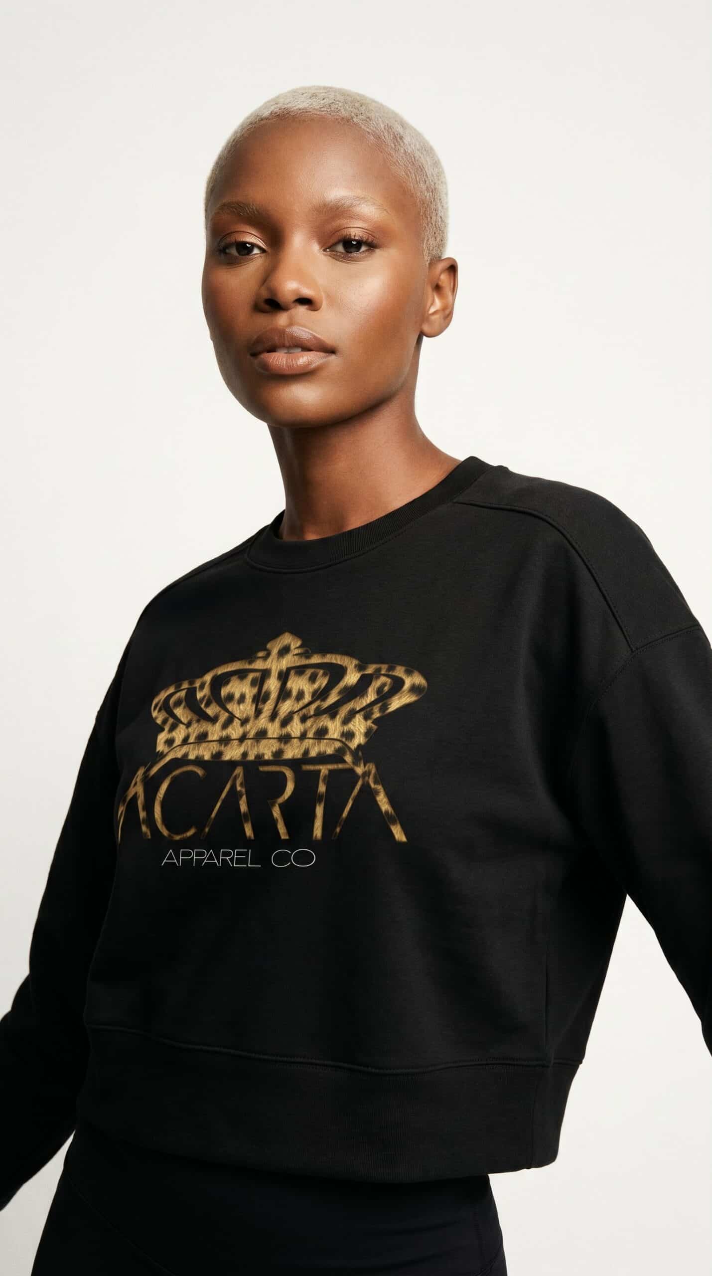 Black sweatshirt with gold "MCAT" logo and crown, urban streetwear style.