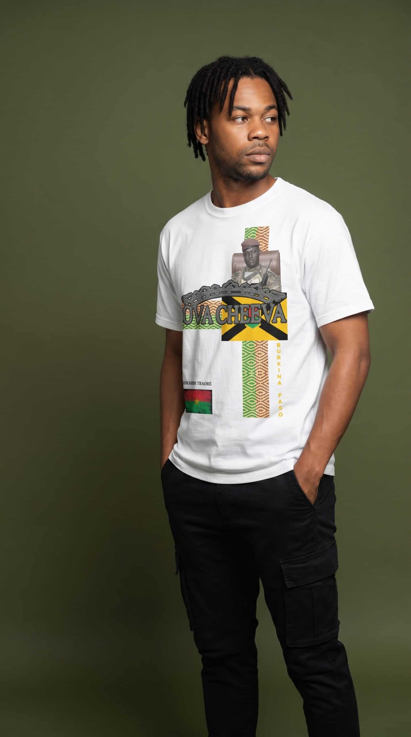 Young man wearing urban apparel with cultural graphic design on a green background.