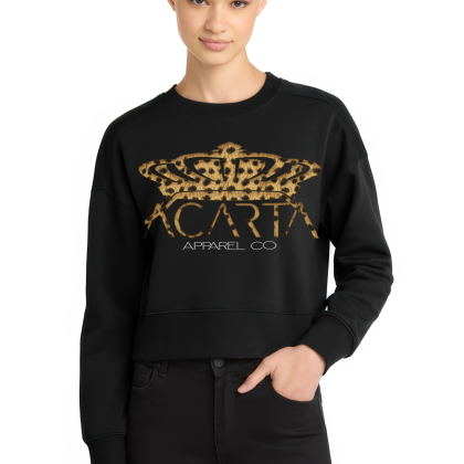 A person with short blond hair wears the Leopard Print Women’s Perfect Weight Fleece Cropped Crew, featuring a black design with a leopard print crown and ACARTA APPAREL CO text, standing against a white background with one hand in their pocket.