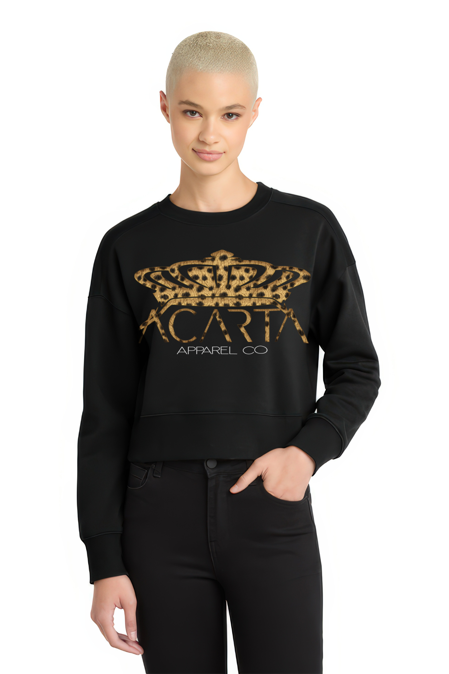 A person with short blond hair wears the Leopard Print Women’s Perfect Weight Fleece Cropped Crew, featuring a black design with a leopard print crown and ACARTA APPAREL CO text, standing against a white background with one hand in their pocket.