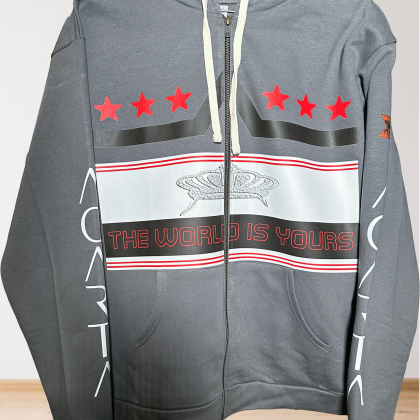 The Mens Adult Heavy Metal The World Is Yours Zip Hoodie features a gray zip-up design with white drawstrings, red stars and globe graphic on the chest, "THE WORLD IS YOURS" in red, white sleeve graphics, and a logo patch on the left arm.