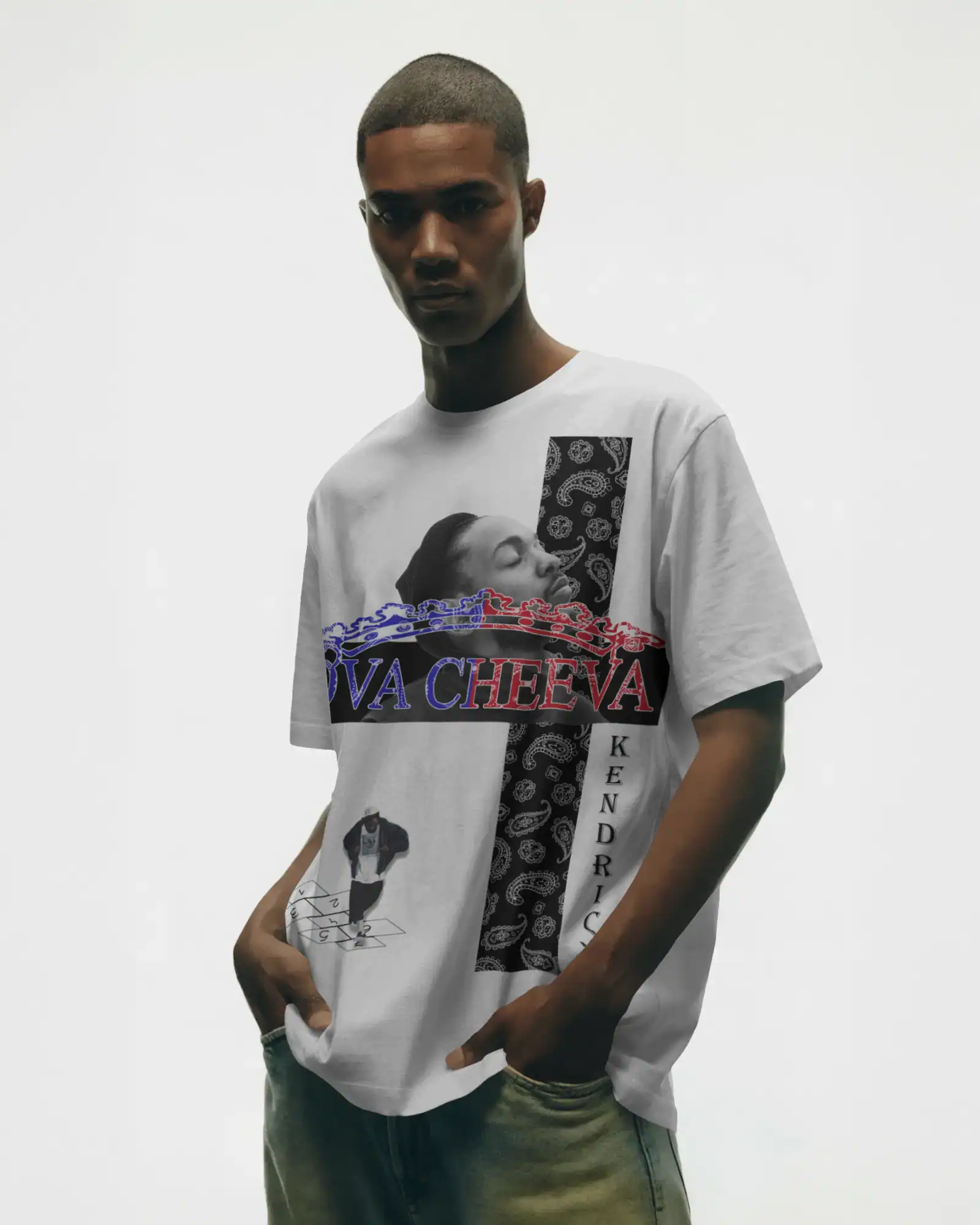 A young man stands against a plain background wearing a white graphic t-shirt featuring artistic black-and-white illustrations, bold red and blue VA CHEEVA text, and KENDRICK written vertically along one side.
