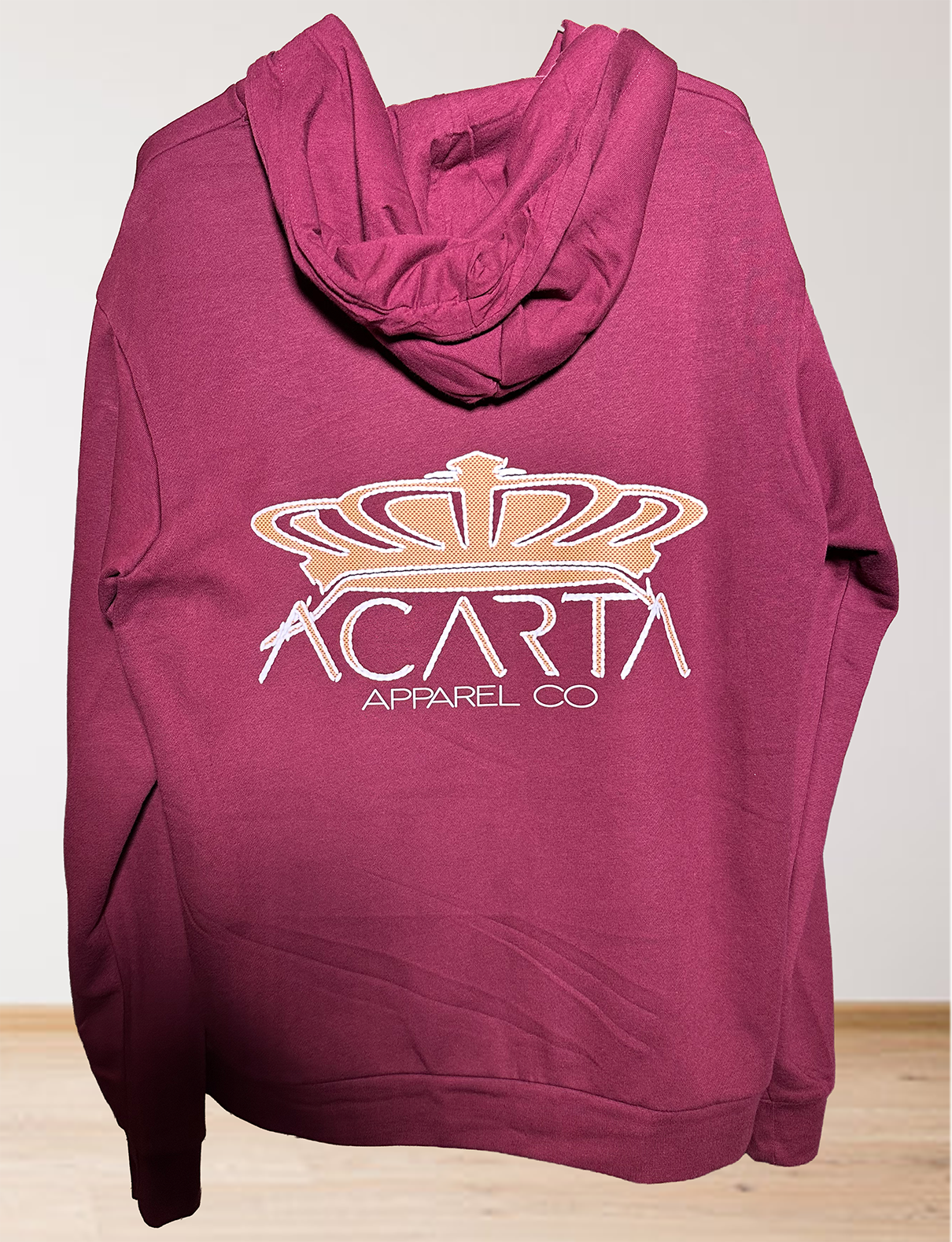 The Mens Adult Maroon The World Is Yours Zip Hoodie features a large gold crown graphic and “ACARTA APPAREL CO” text on the back, shown against a light background.