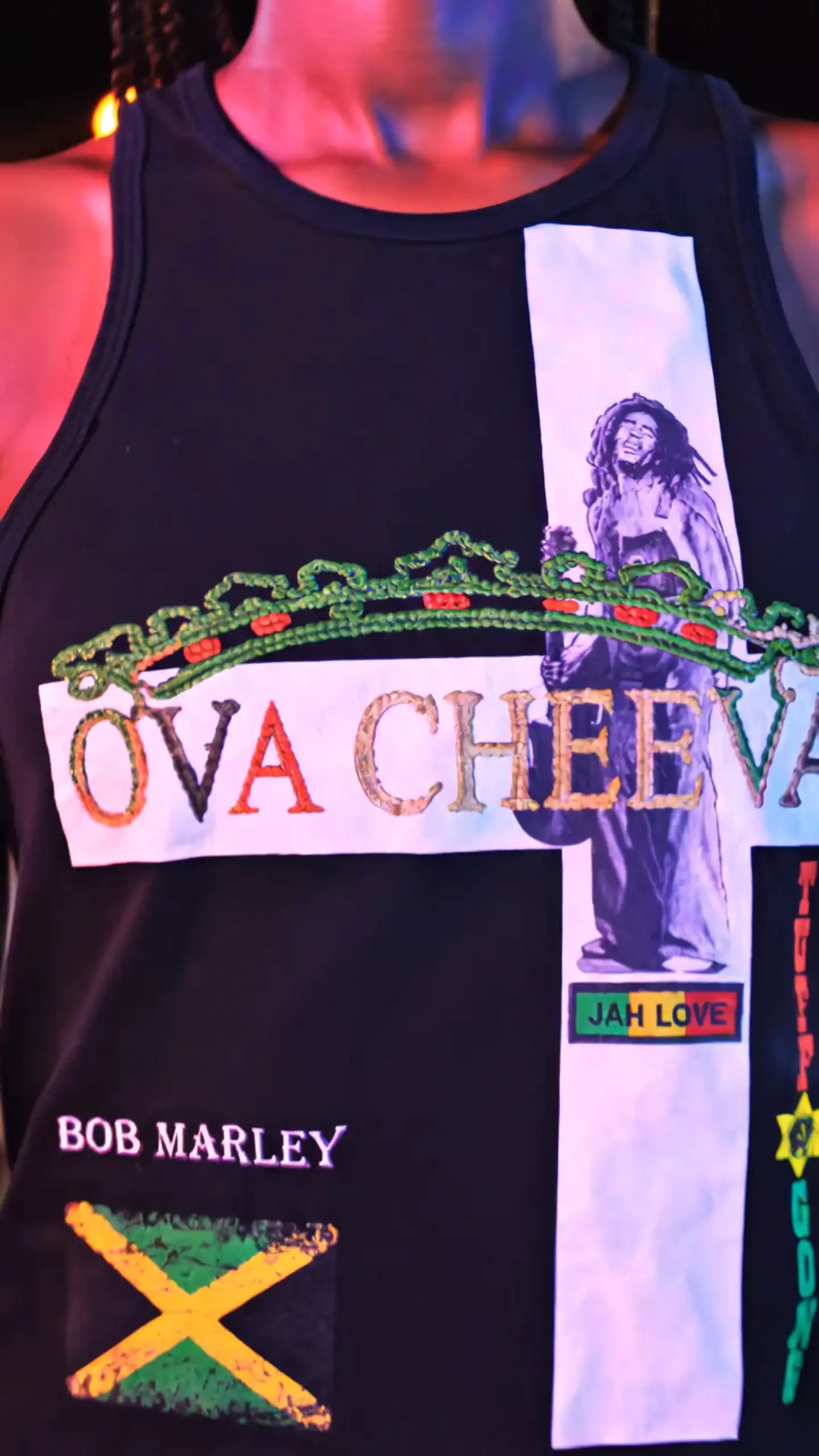 Black tank top with Bob Marley design, "OVA CHEEVA" text, and Jamaican flag.