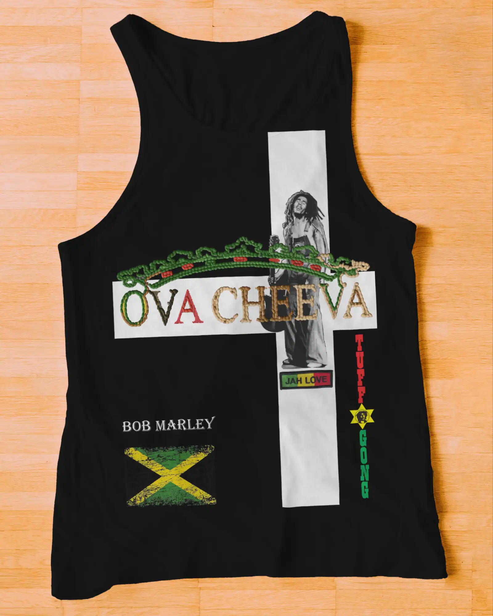 The OVA CHEEVA Women's Light Weight Tank Top features Bob Marley, the Jamaican flag, and reggae-inspired text—OVACHEEVA, BOB MARLEY, JAH LOVE, TUFF GONG—in colorful cross heart designs on a black background.