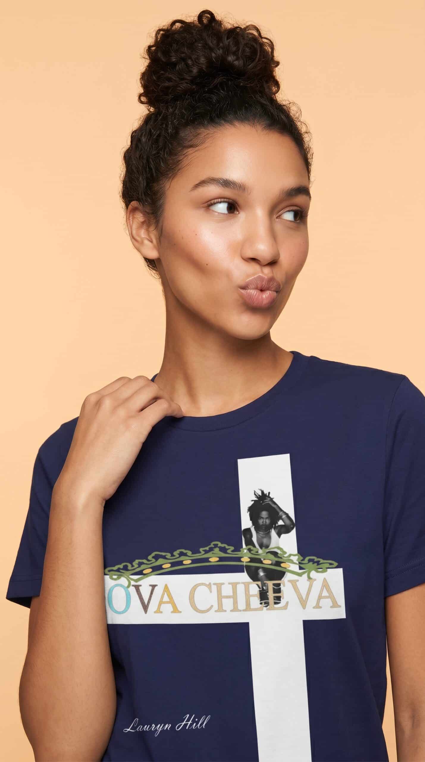 A woman with curly hair styled in a high bun wearing a navy blue T-shirt with a graphic design.