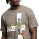 Urban fashion model wearing graphic T-shirt with reggae and Jamaican flag design.