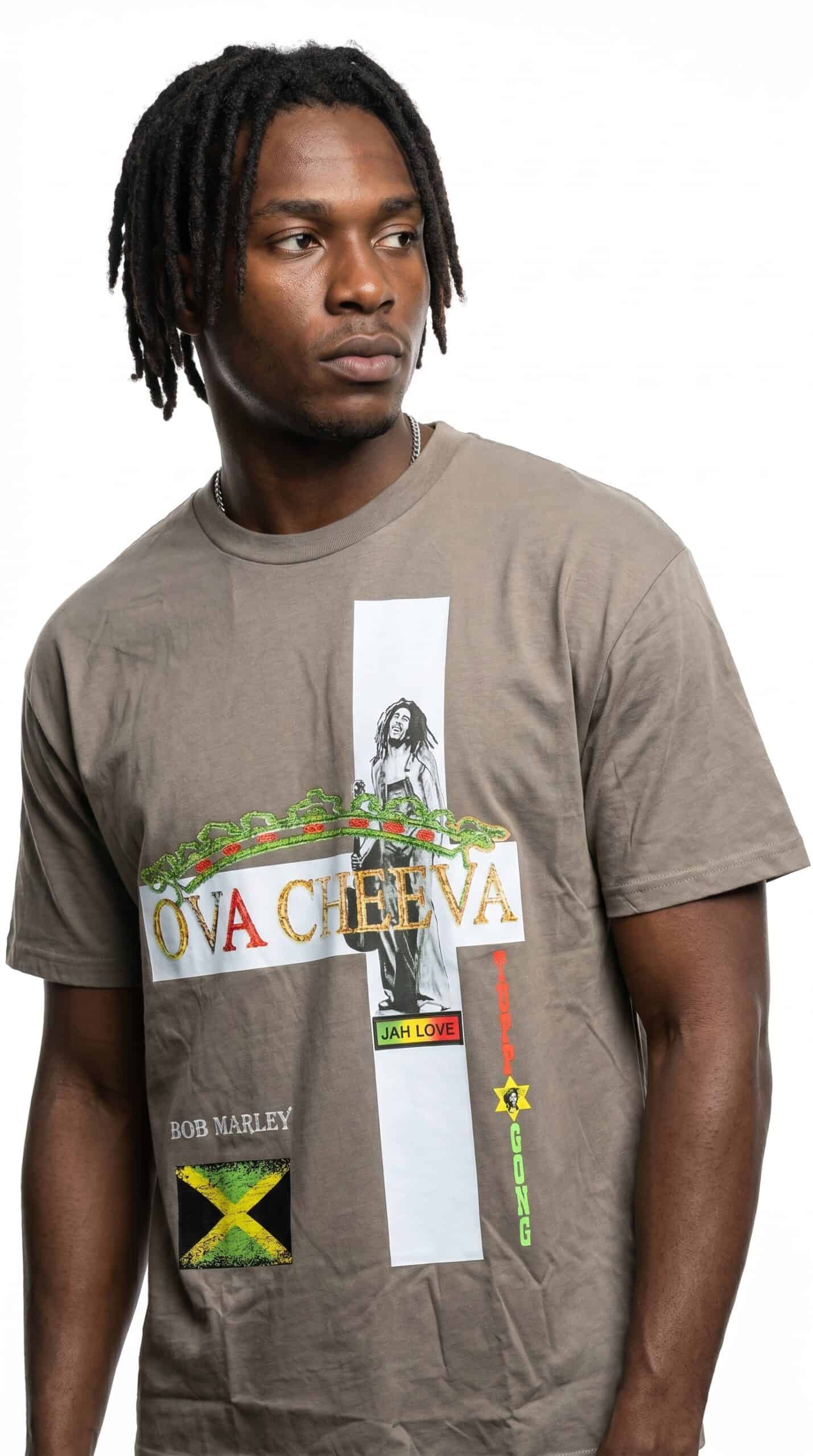 Urban fashion model wearing graphic T-shirt with reggae and Jamaican flag design.