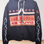 Black hoodie with "THE MUNDO ES TUYO" text and star designs on front.