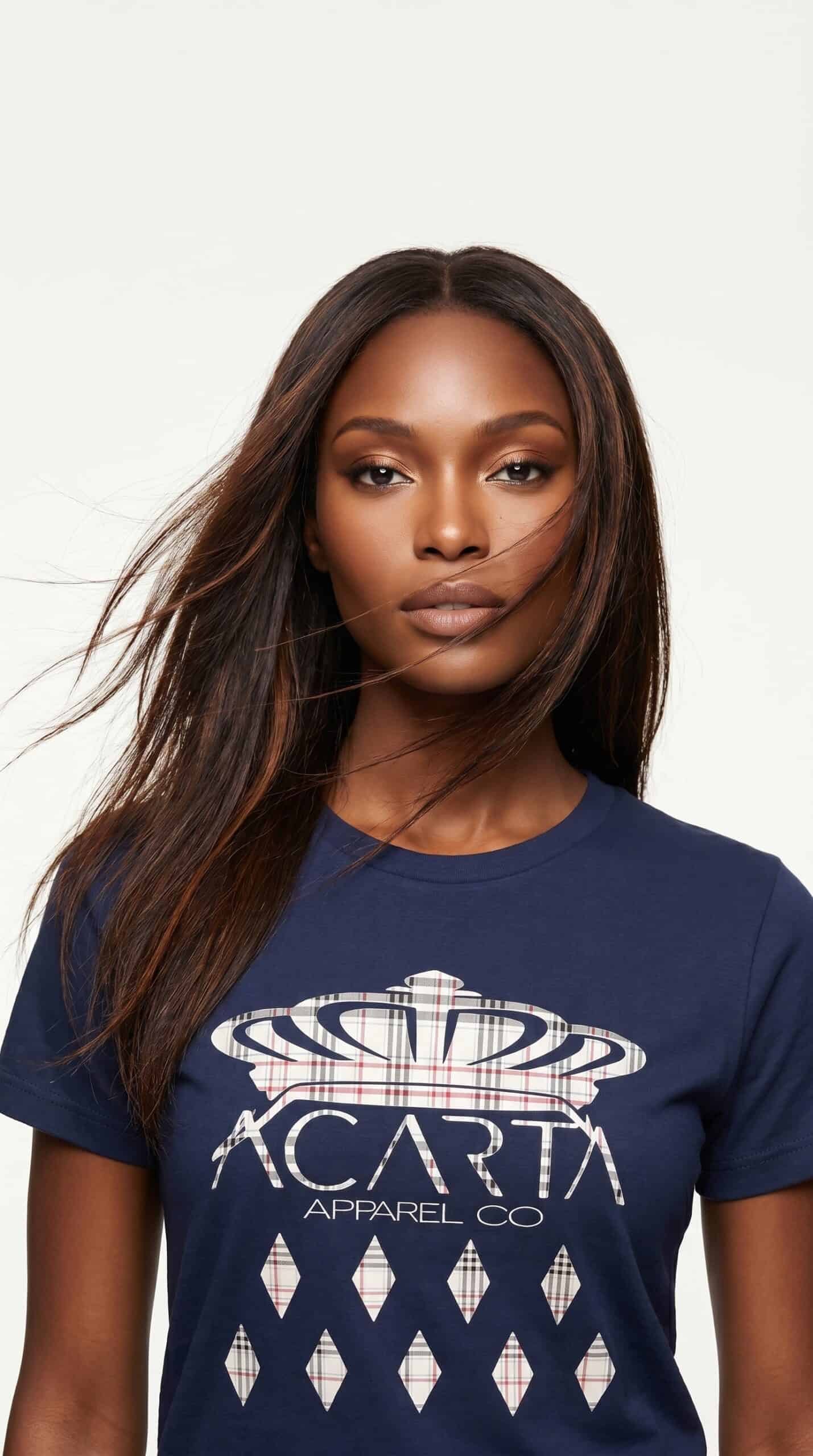 A woman with long, straight hair wearing a navy blue T-shirt featuring the Too Dapper logo.