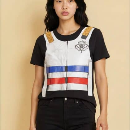 Young woman wearing a police vest-inspired graphic t-shirt and black pants against a beige backgroun.