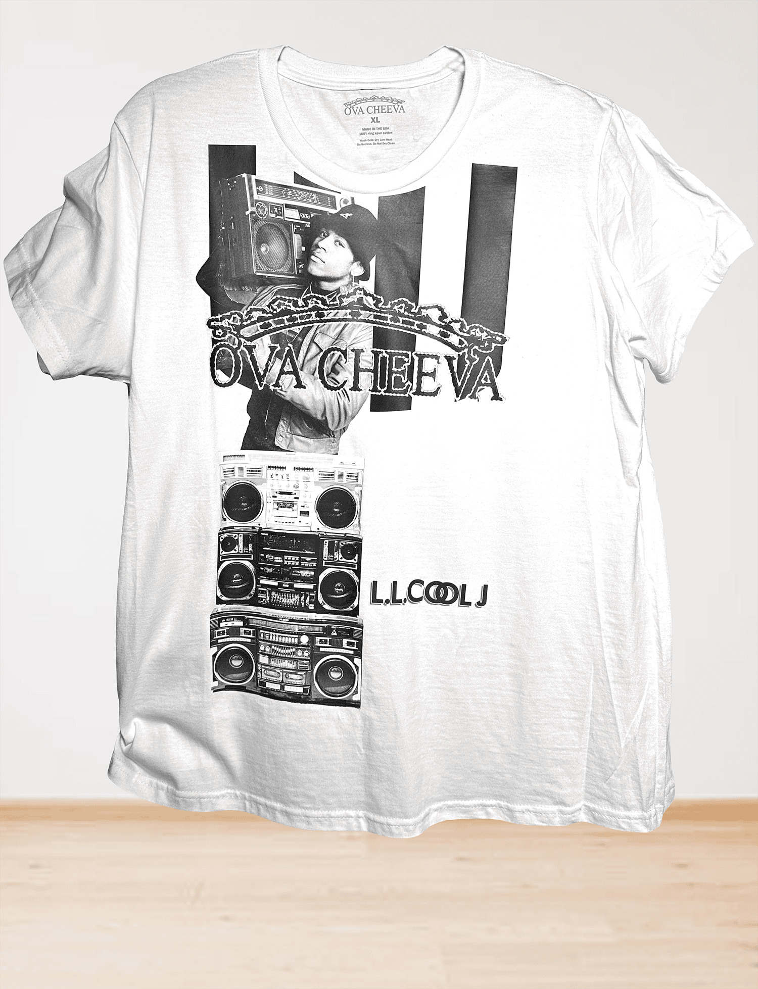 The OVA CHEEVA Men's LL Cool J Graphic T-Shirt features black-and-white artwork of a person with a boombox, large OVA CHEEVA text, vertical black bars, stacked boomboxes, and LL COOL J at the bottom.